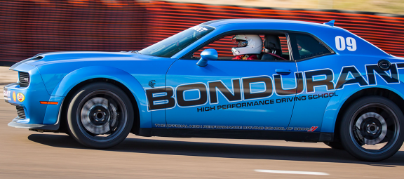 Carolyn driving at Bondurant