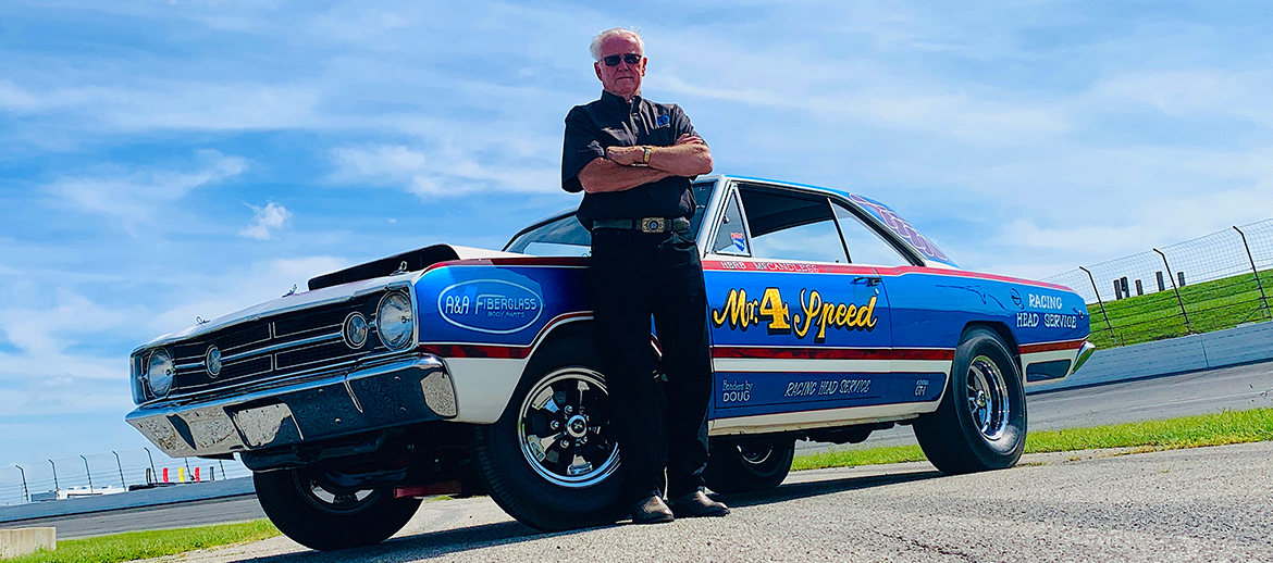 Herb McCandless standing next to his race car