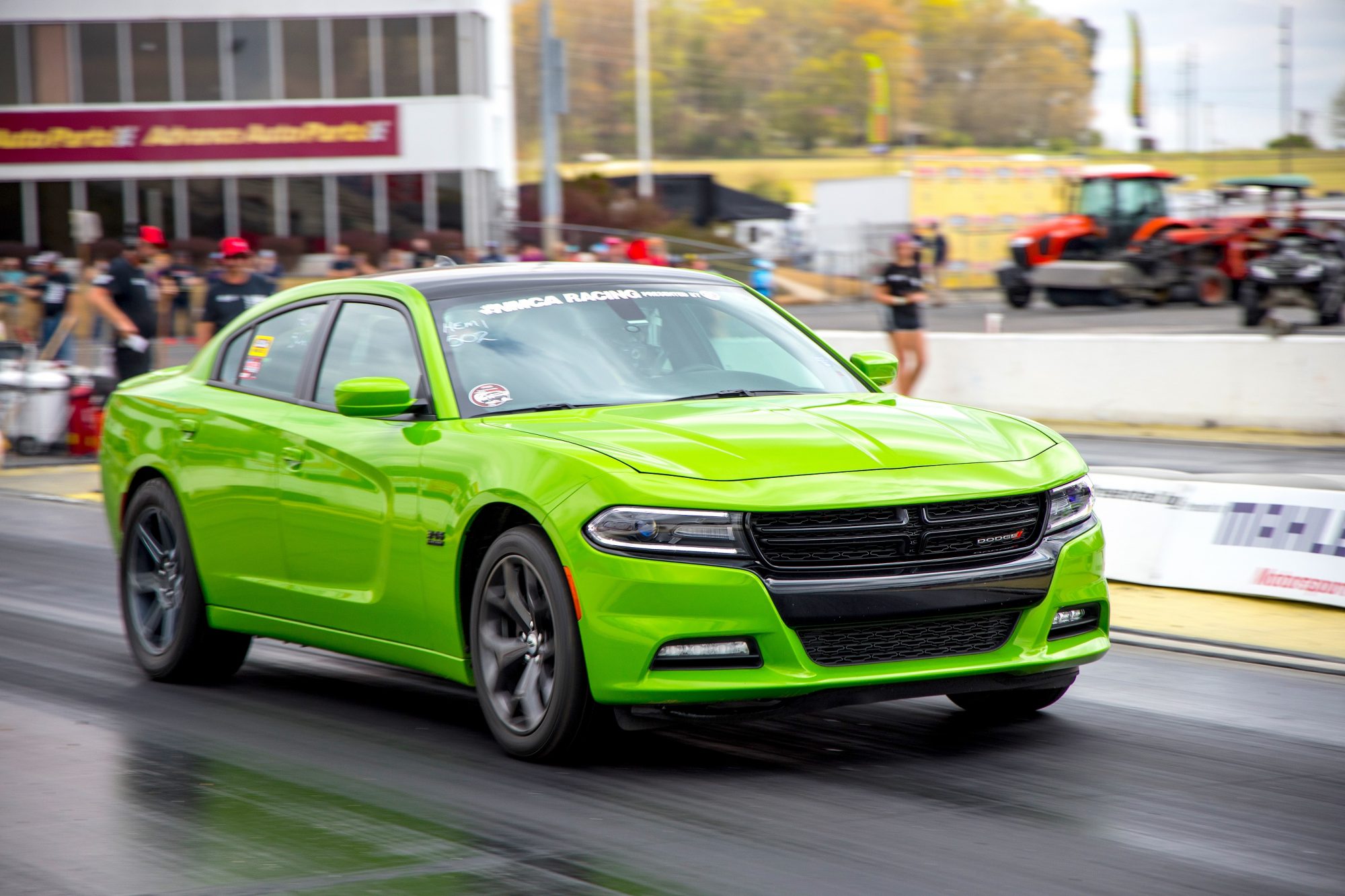 Green Dodge Charger drag racing at NMCA race