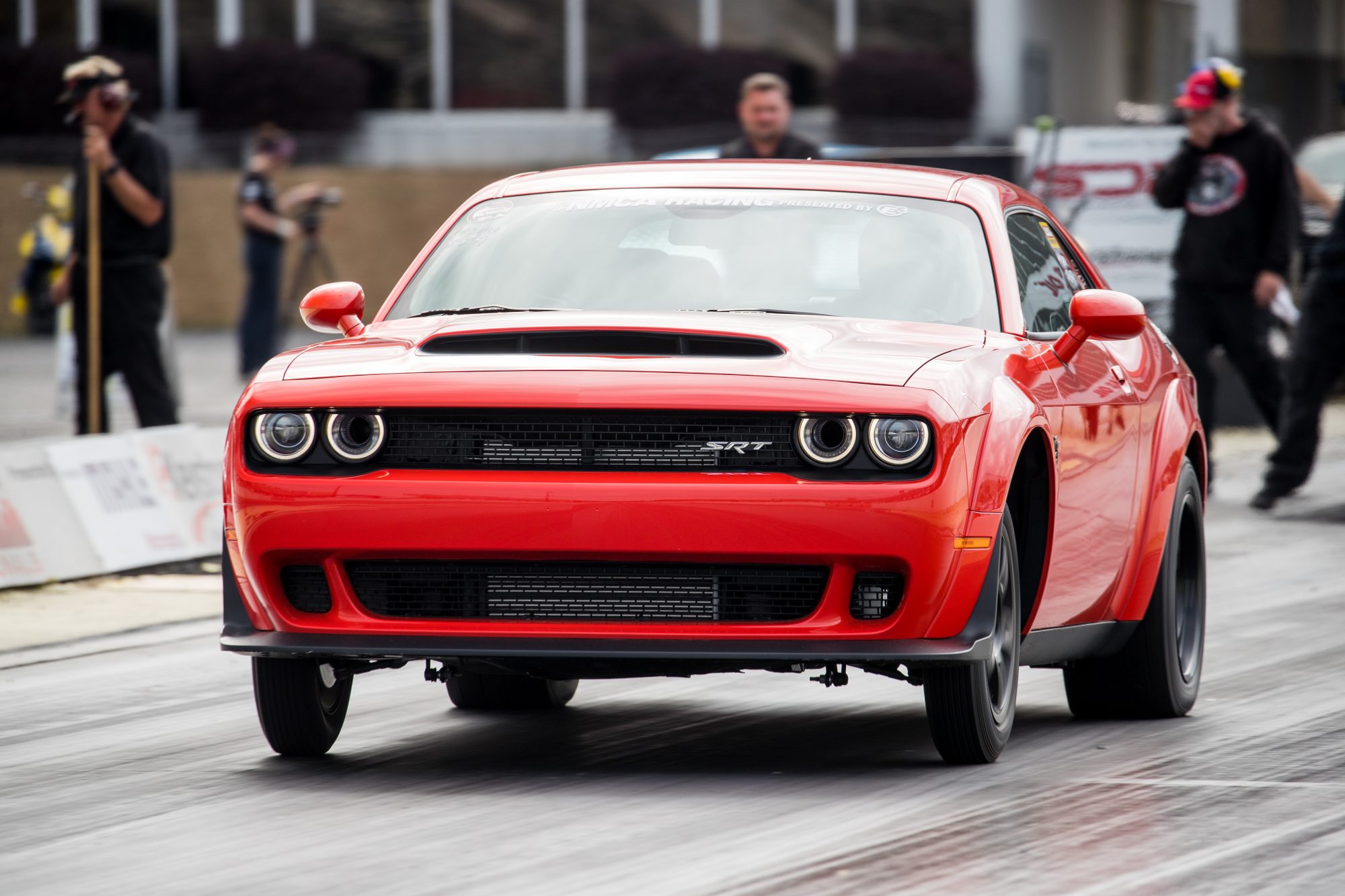 Red Dodge Challenger drag racing at NMCA event