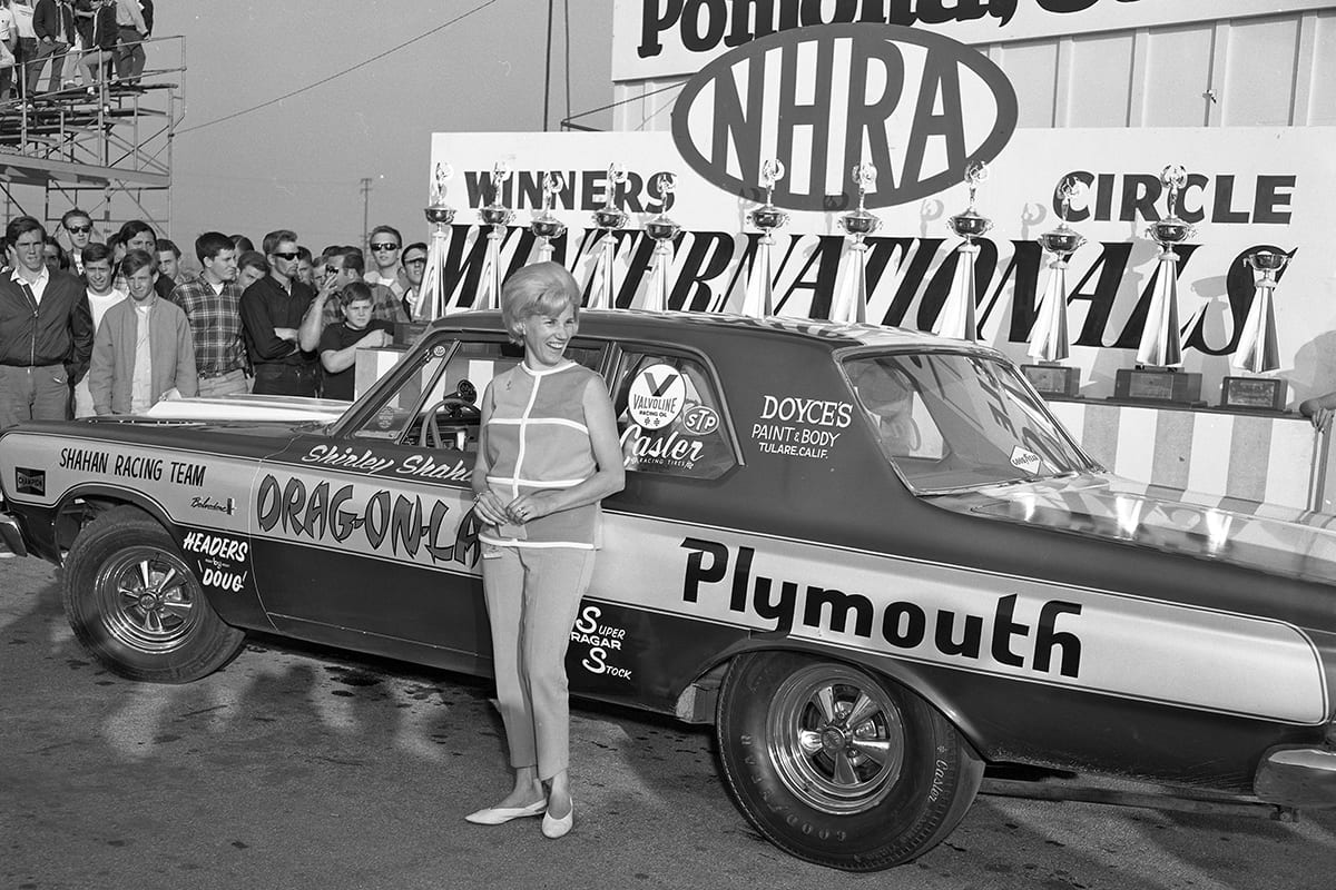 Shirley Shahan standing in front of her drag car