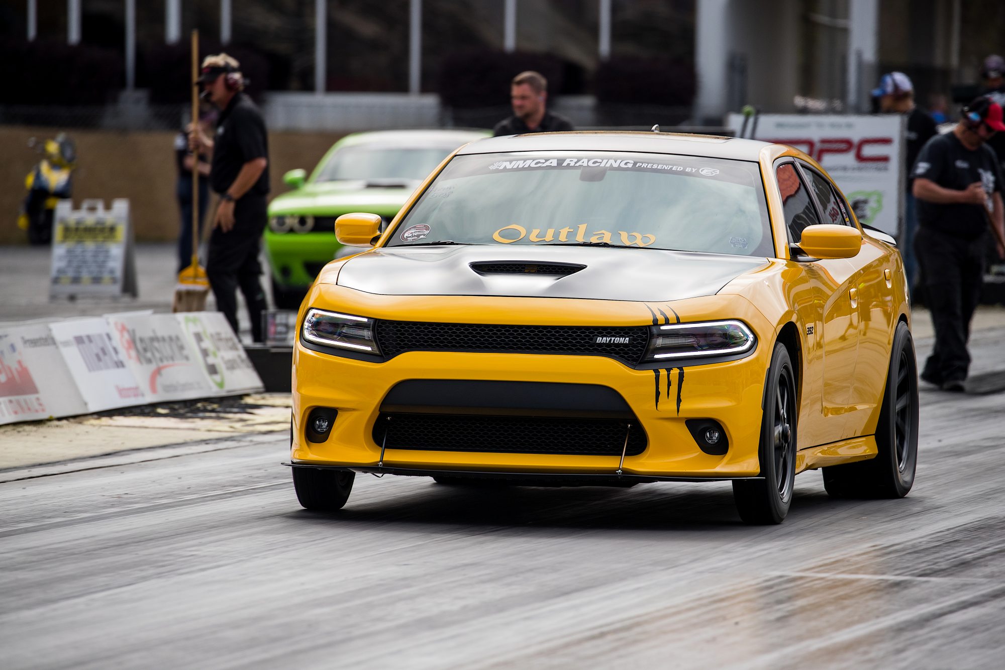 Yellow Dodge Charger drag racing at NMCA event