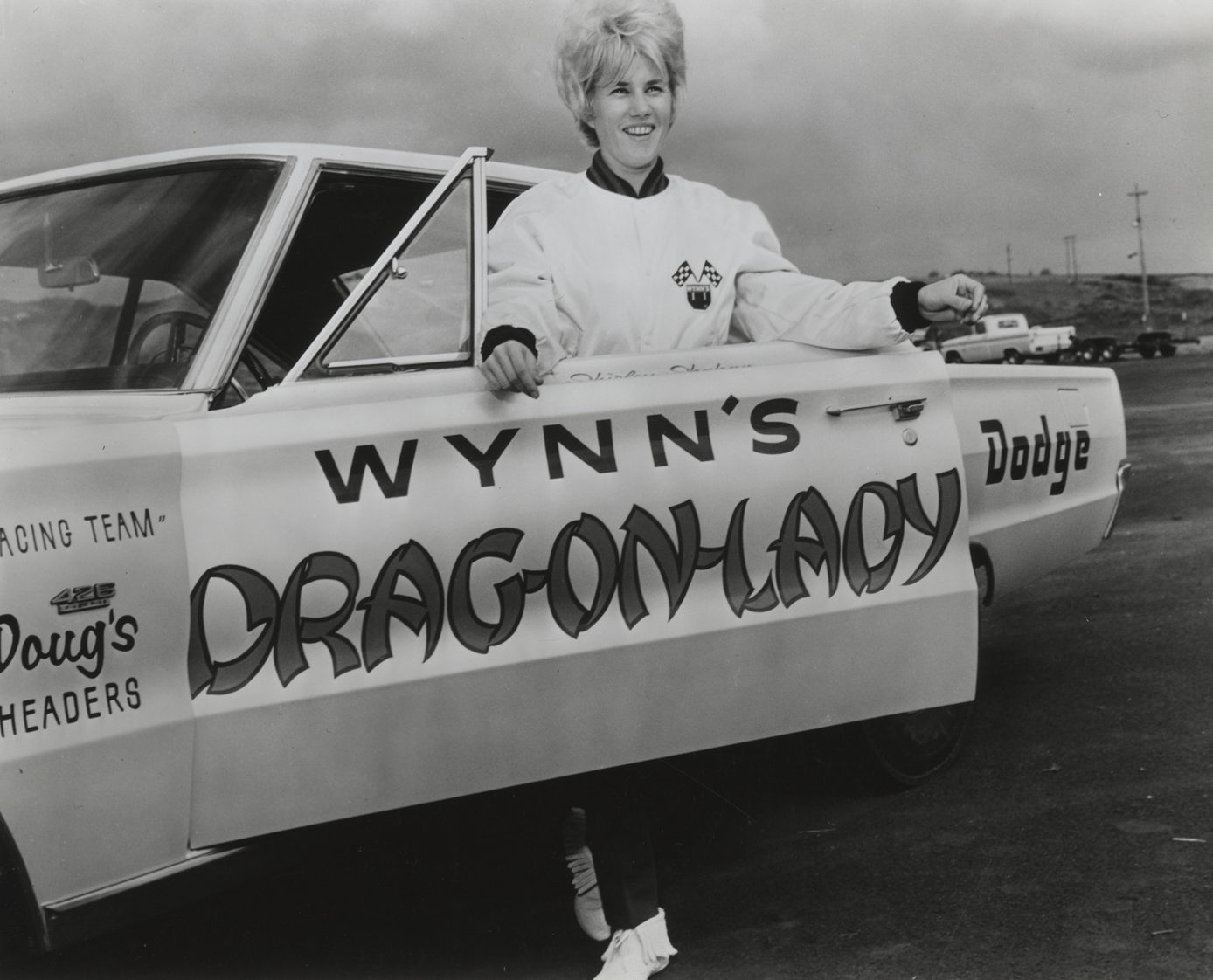 Shirley standing next to her drag car