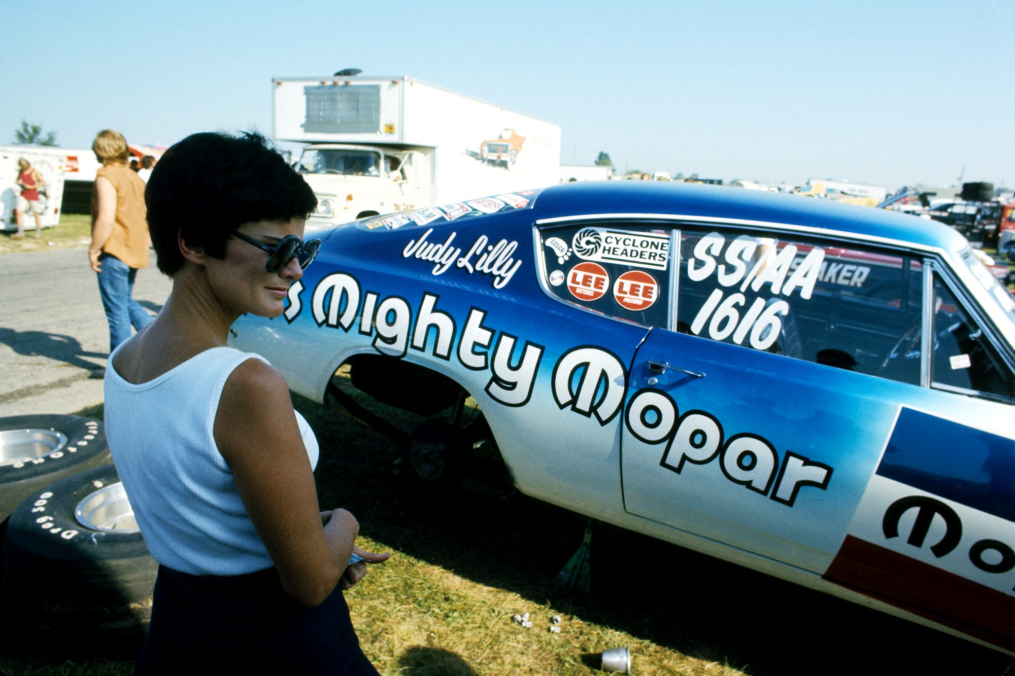 Judy Lilly standing outside of her drag car