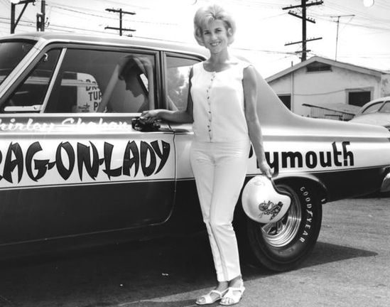 Shirley Shahan posing next to her drag car