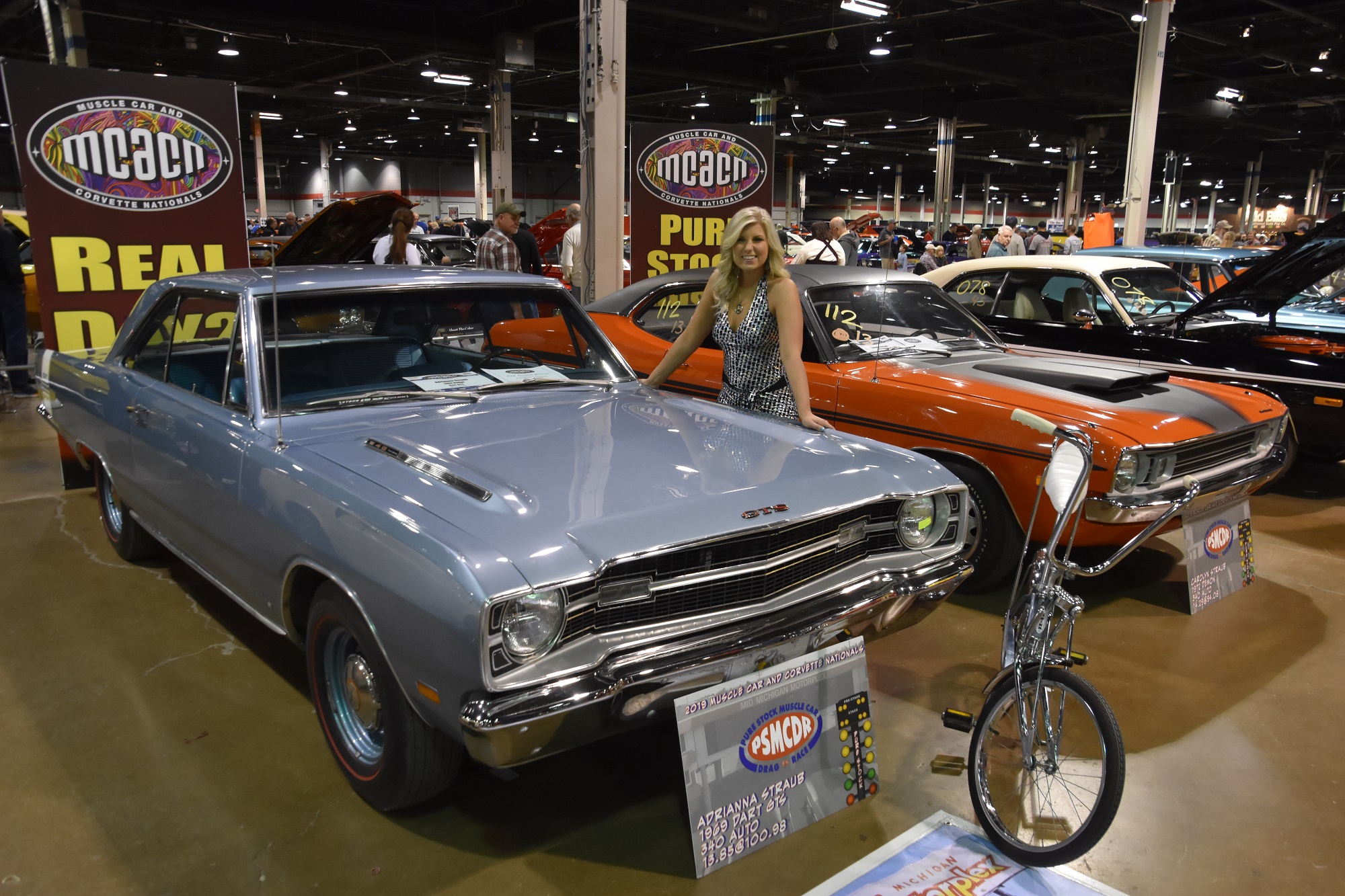 Adrianna Straub posing with her car