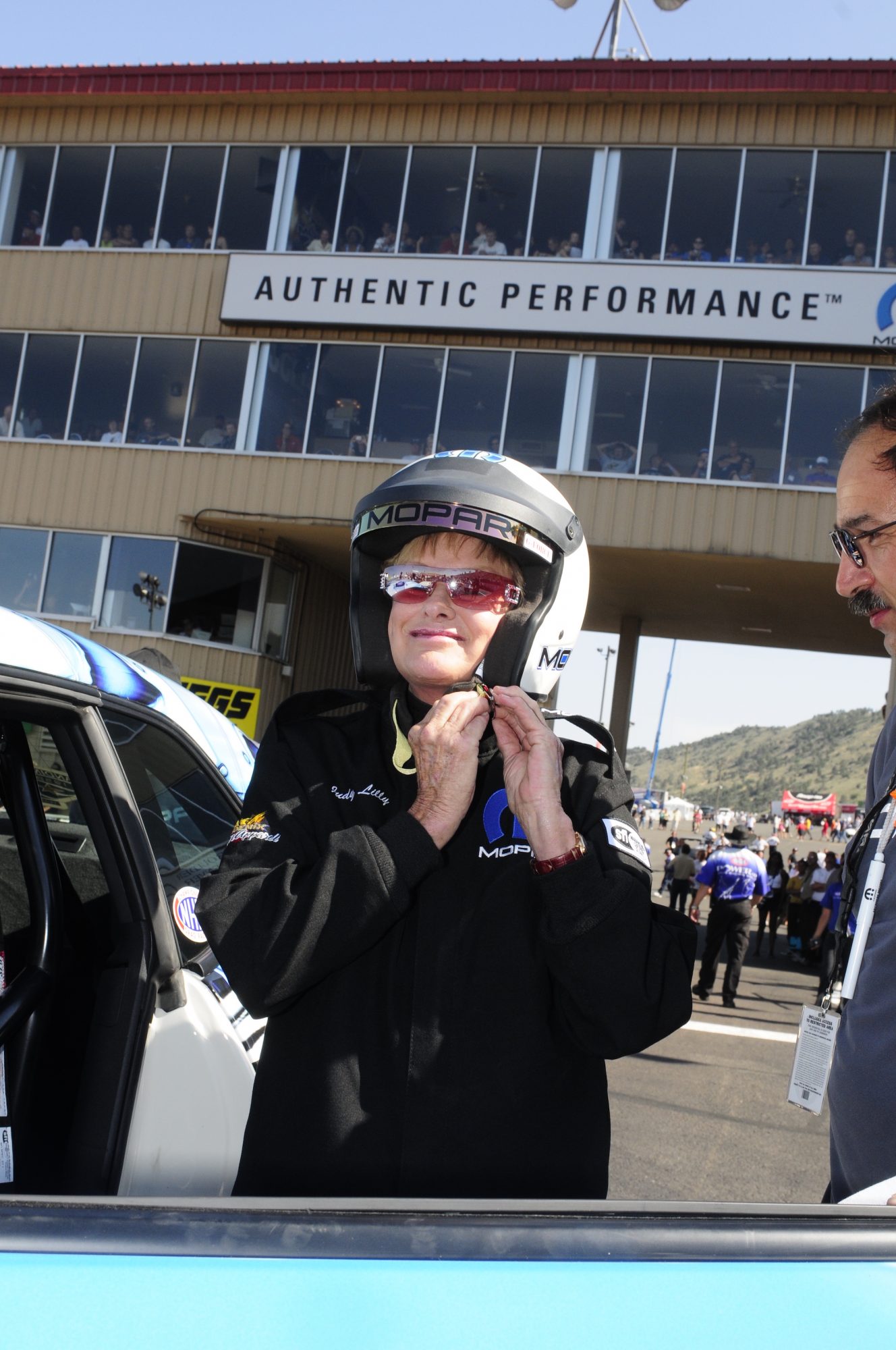 Judy Lilly strapping on a Mopar helmet