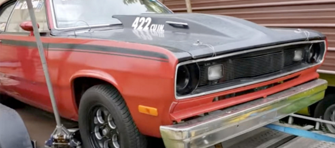 Classic vehicle tied to a trailer