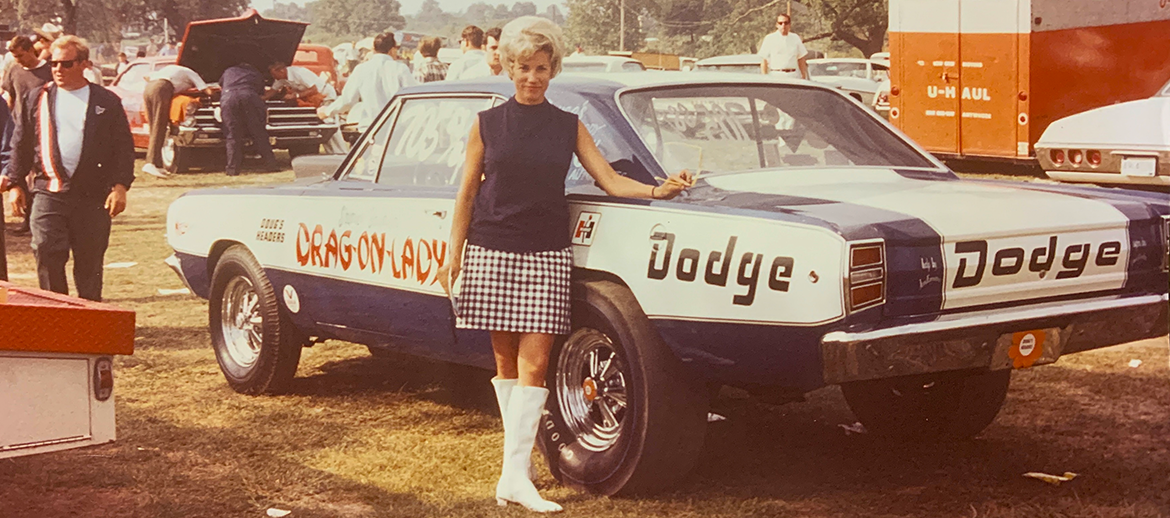 Shirley standing next to her drag car