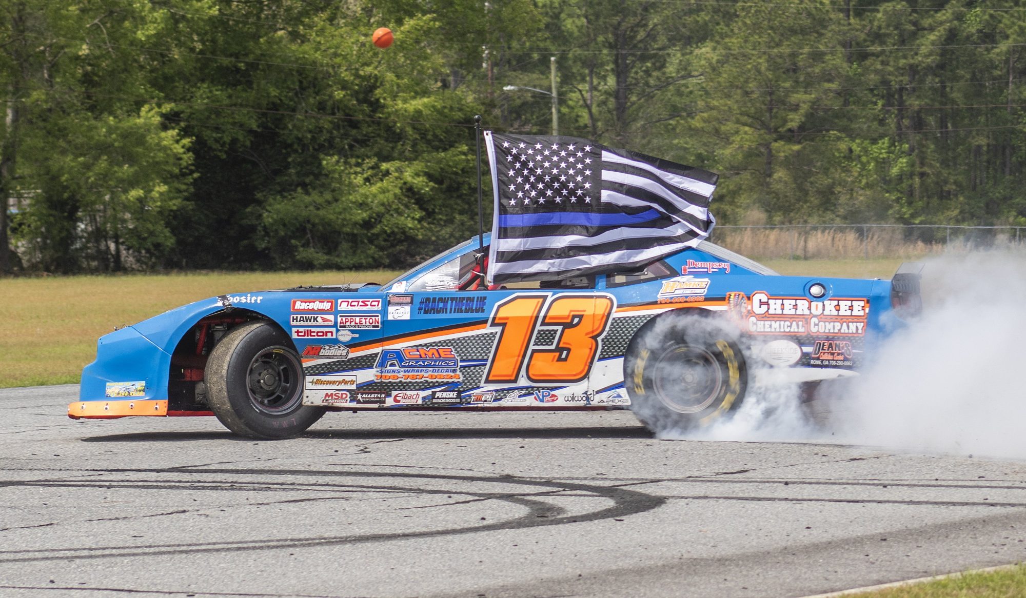 Challenger doing a burnout with a police flag