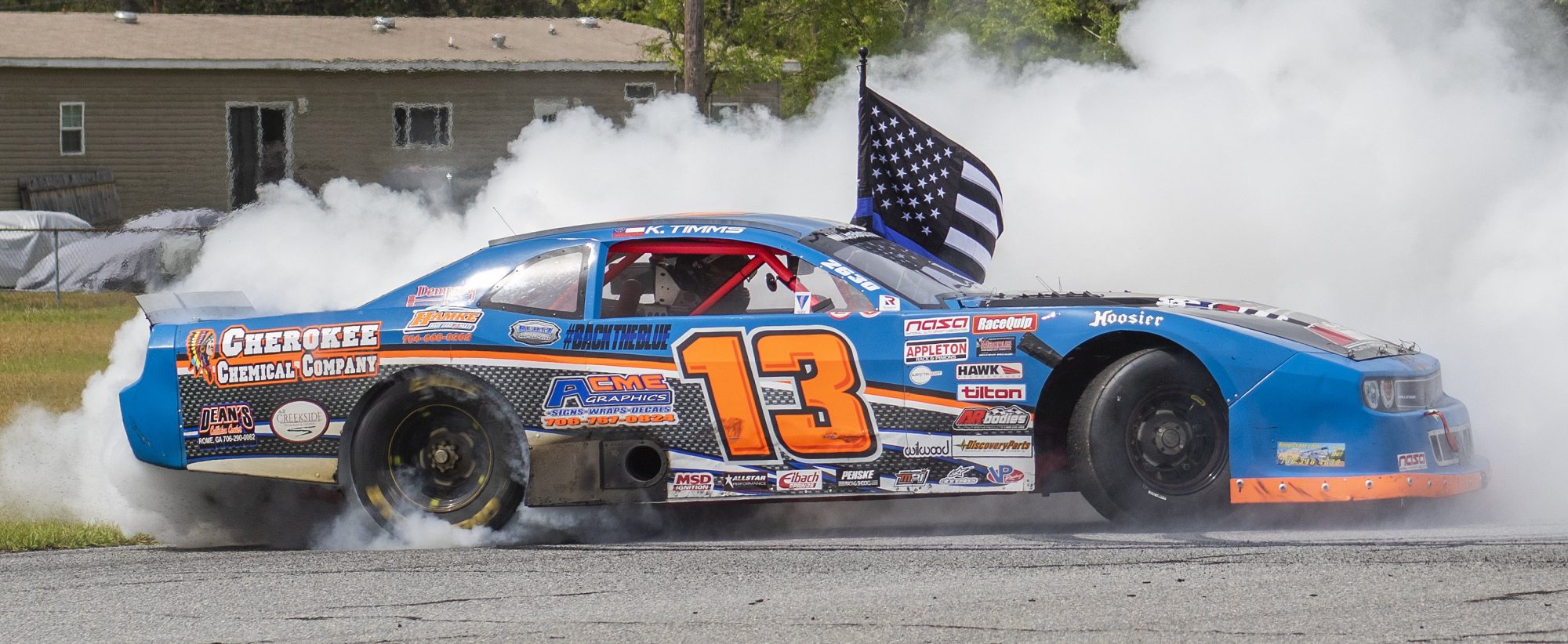 Challenger doing a burnout with a police flag