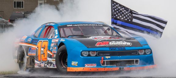 Challenger doing a burnout with a police flag