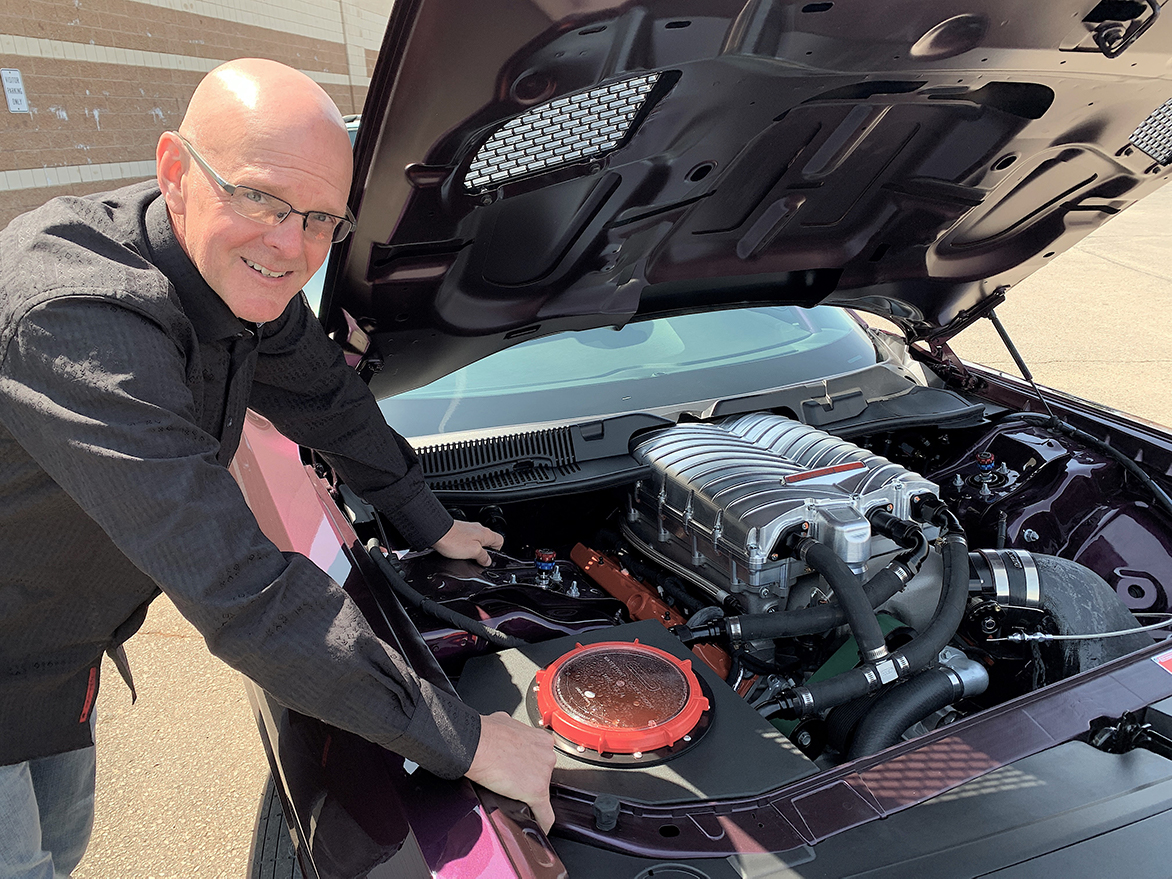 Man with his 2021 Dodge Challenger Mopar Drag Pak engine