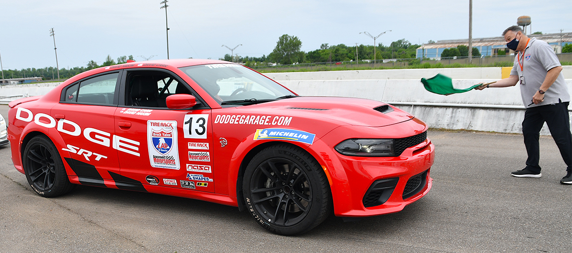 2021 Dodge Charger SRT® Hellcat Redeye on a starting line with a man and a green flag