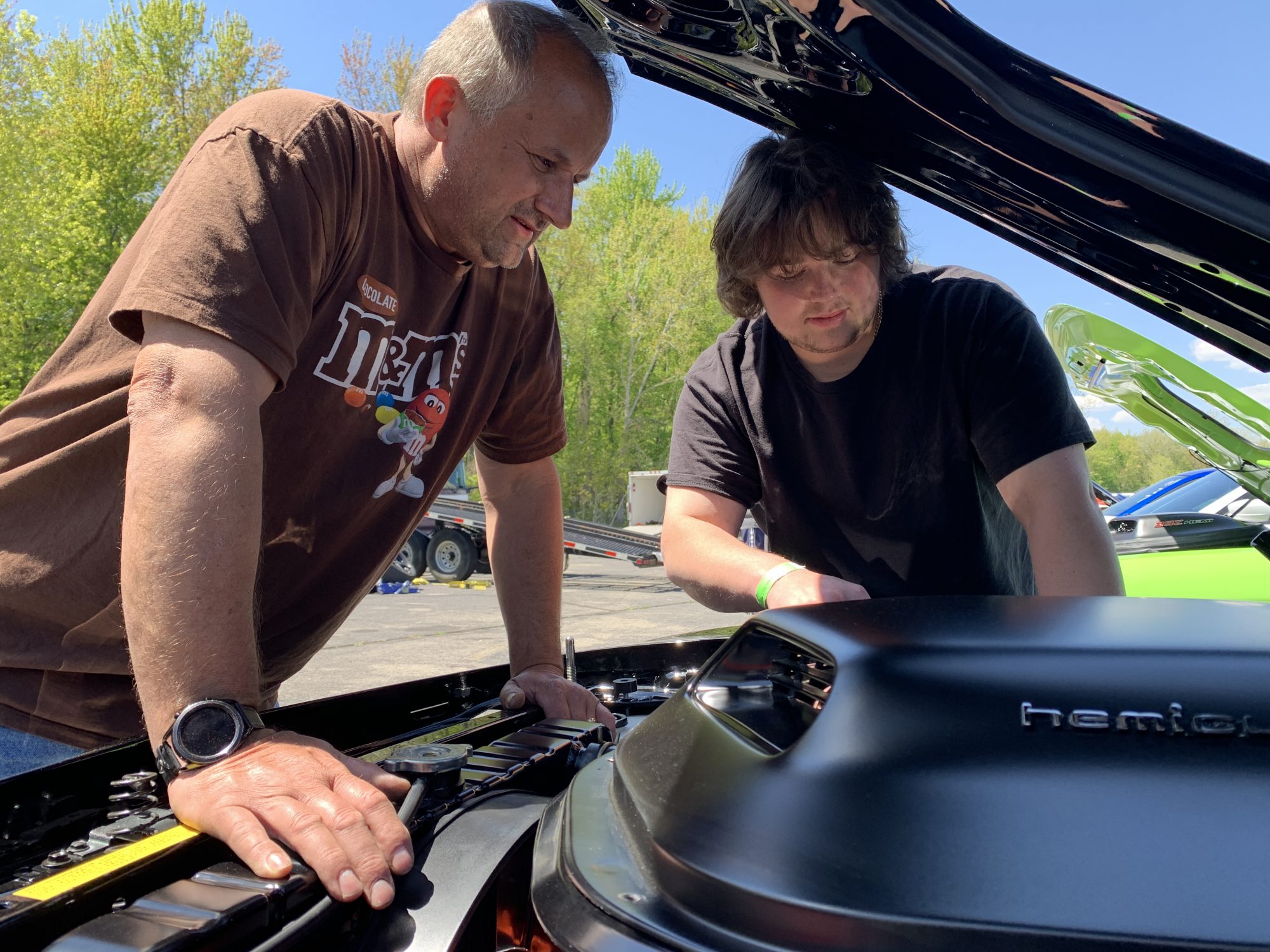 Two men working on a Dodge vehicle