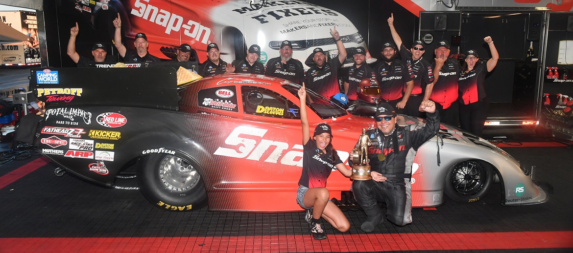 Cruz Pedregon and his crew holding up their Wally for the win