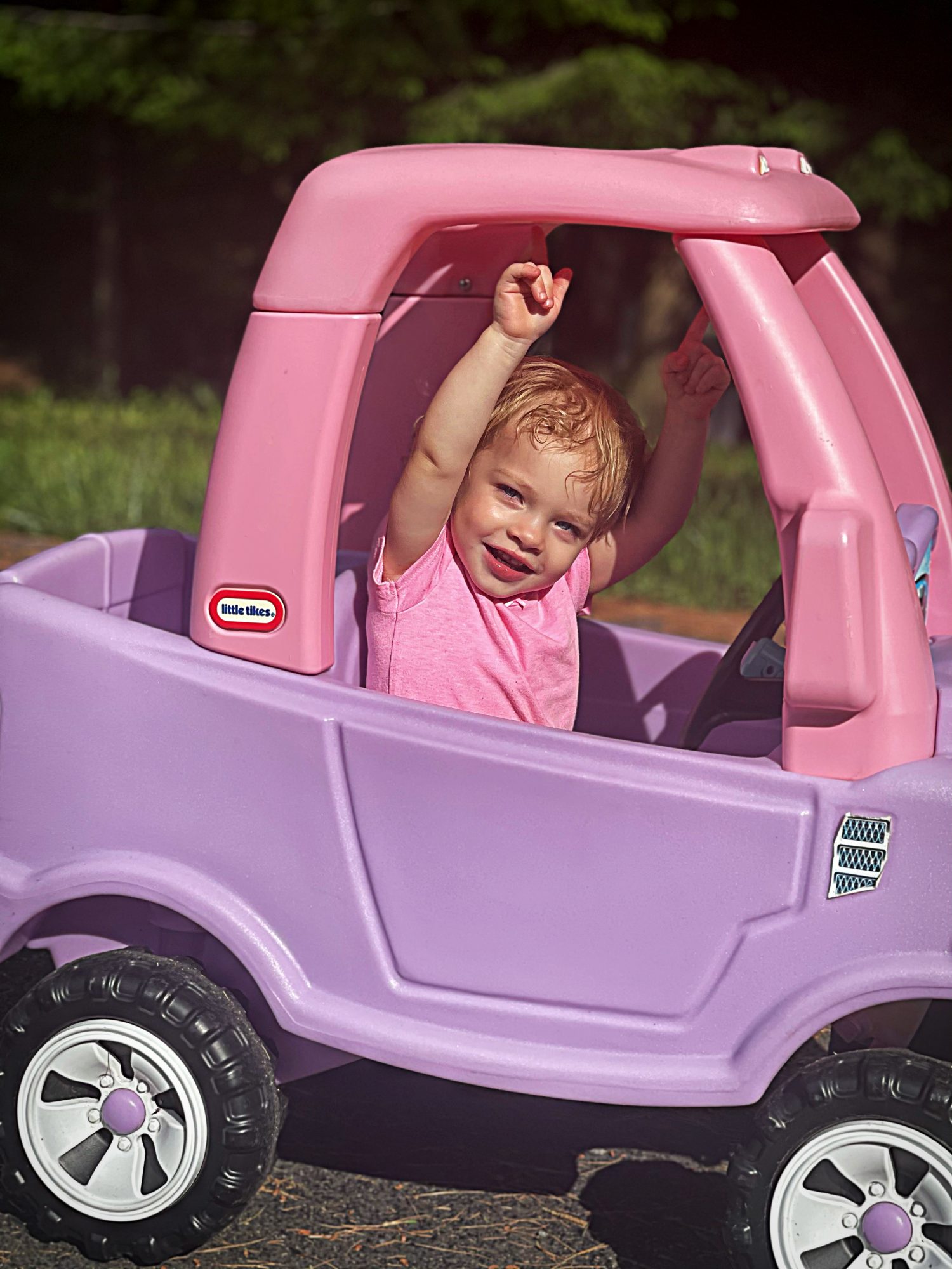 Leah Greenstein in her Little Tikes car