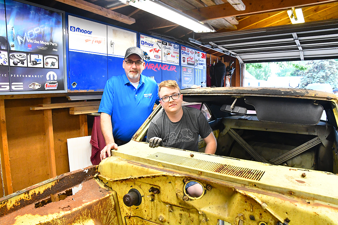 Two men with an old vehicle