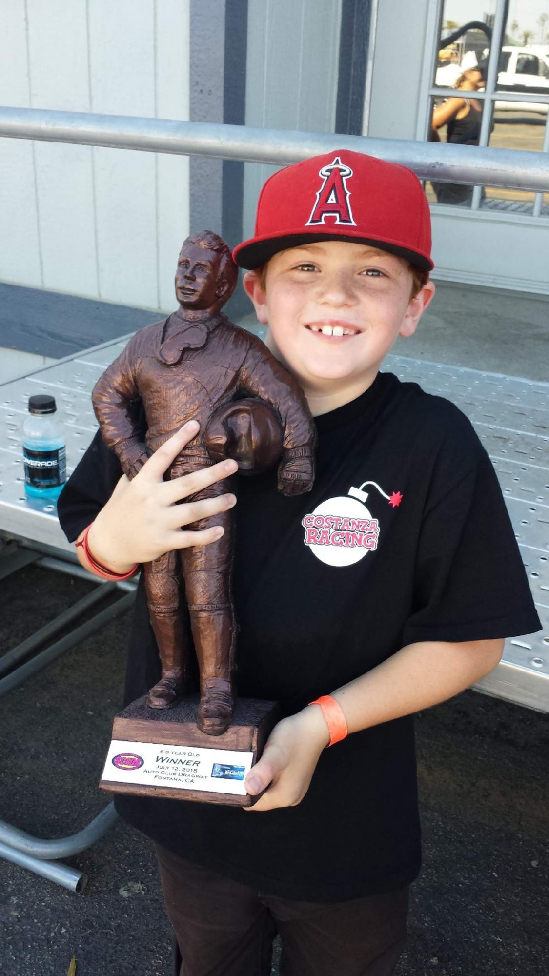 Young boy holding a trophy