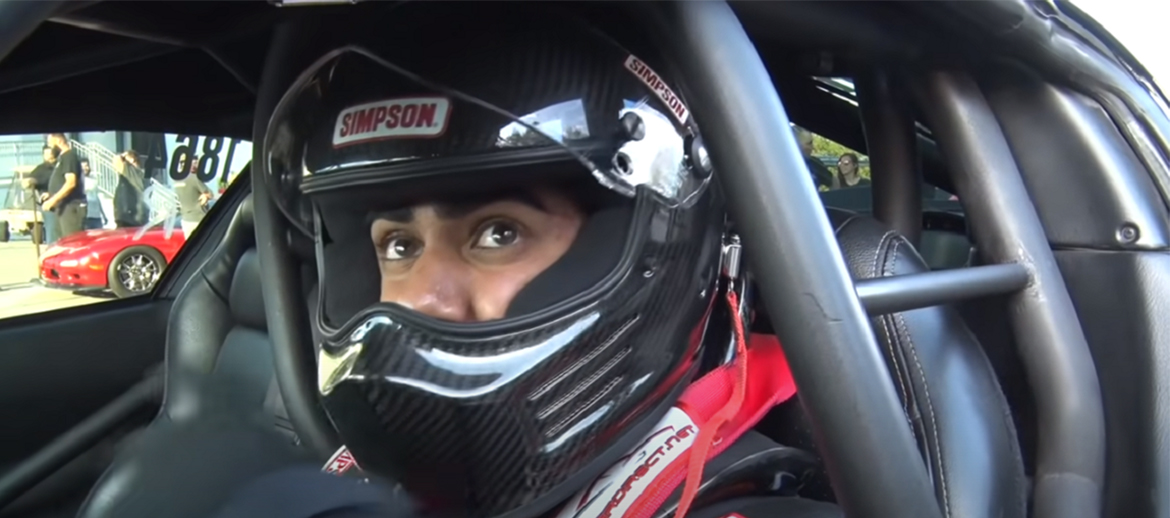 Man wearing a helmet in the driver's seat of a vehicle