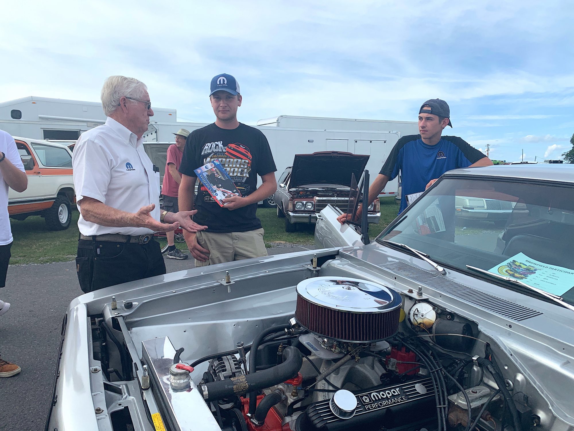 Spectators talking about a vehicle on display