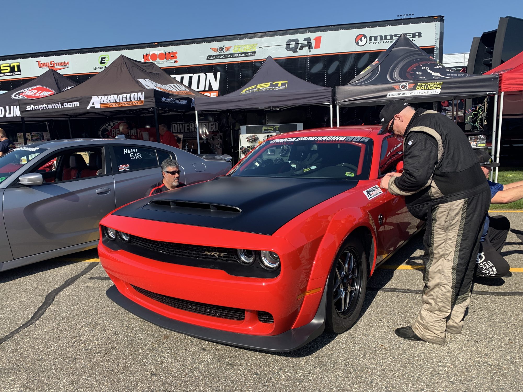 Man taking pictures of his race car