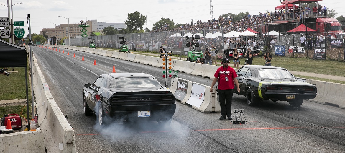 Two cars drag racing at Roadkill Nights Powered by Dodge