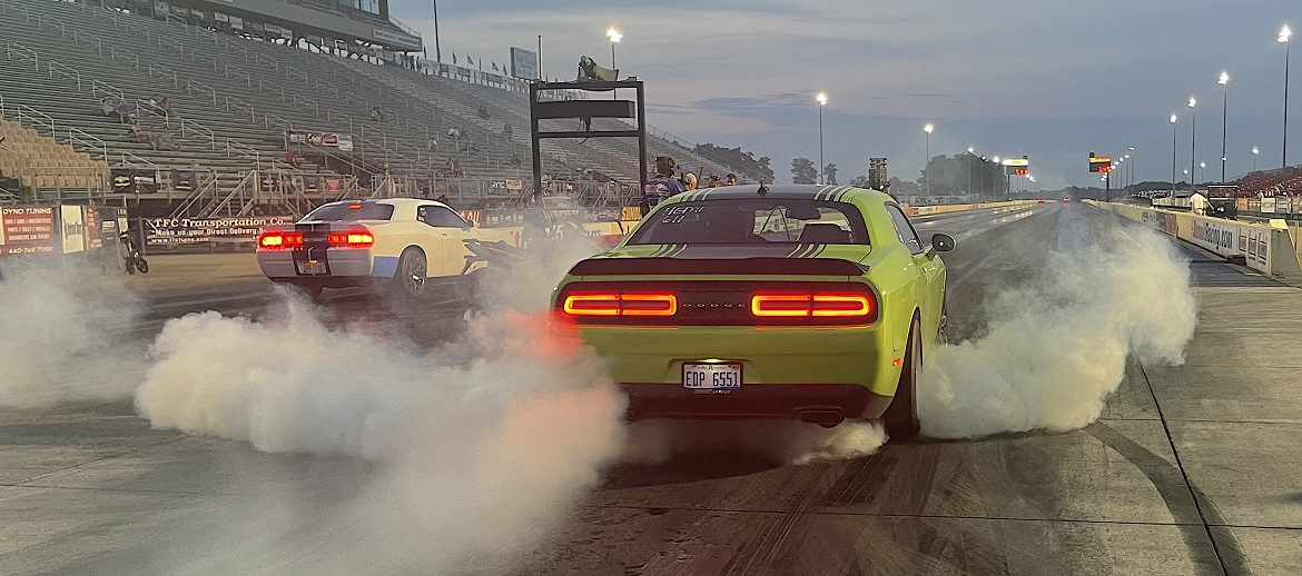 Two challengers doing burnouts prior to drag racing