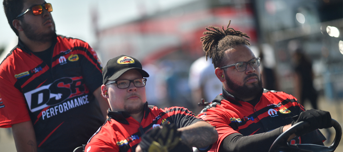 DSR crew members riding in a golf cart