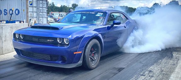 Challenger doing a burnout before drag racing