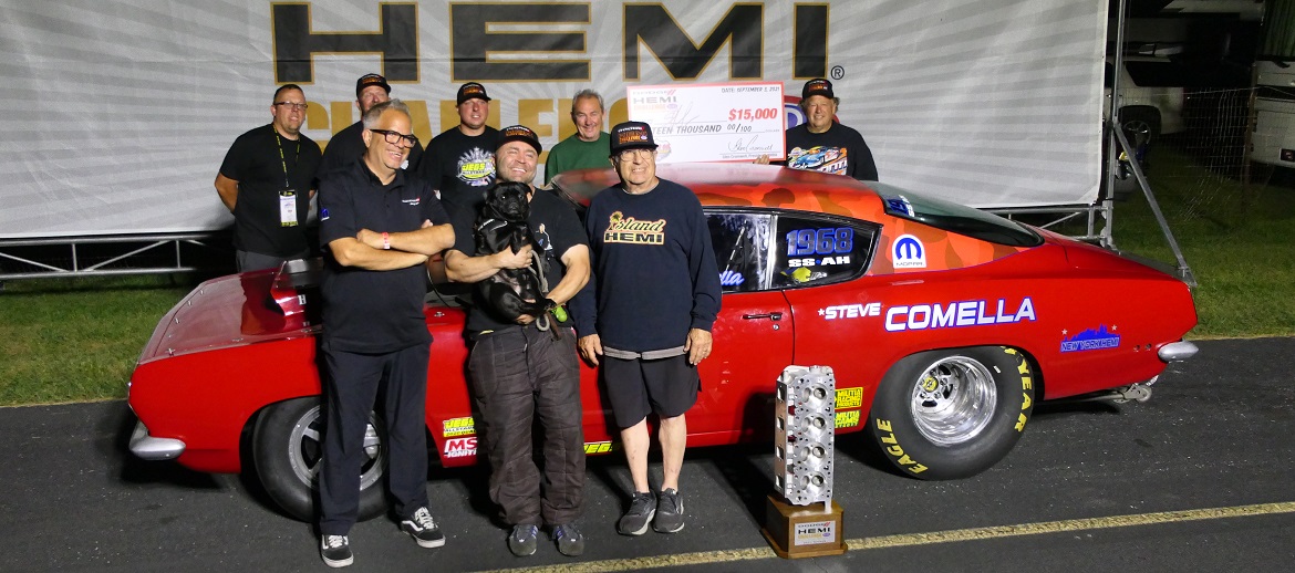 Steve Comella standing in front of his race car