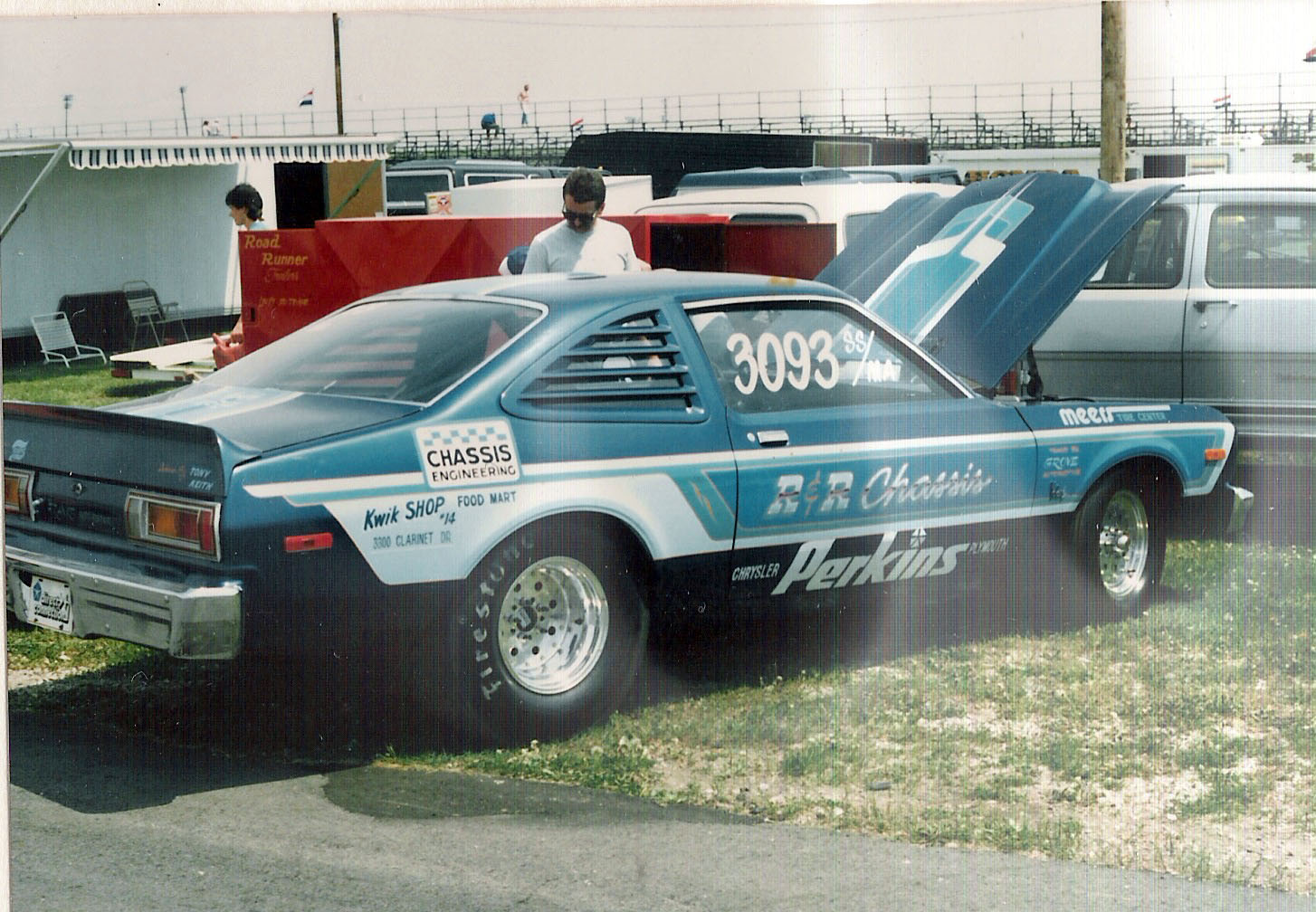 Man looking at a drag car