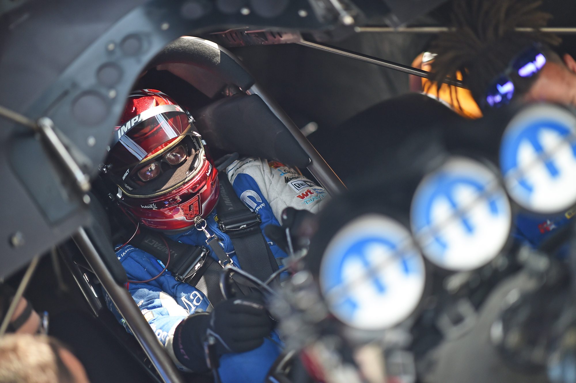 Tommy Johnson Jr sitting in his funny car getting ready to race