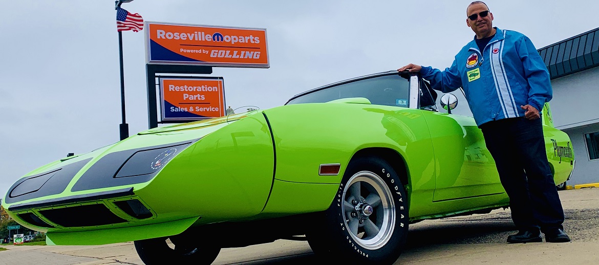 Man standing next to Plymouth Road Runner