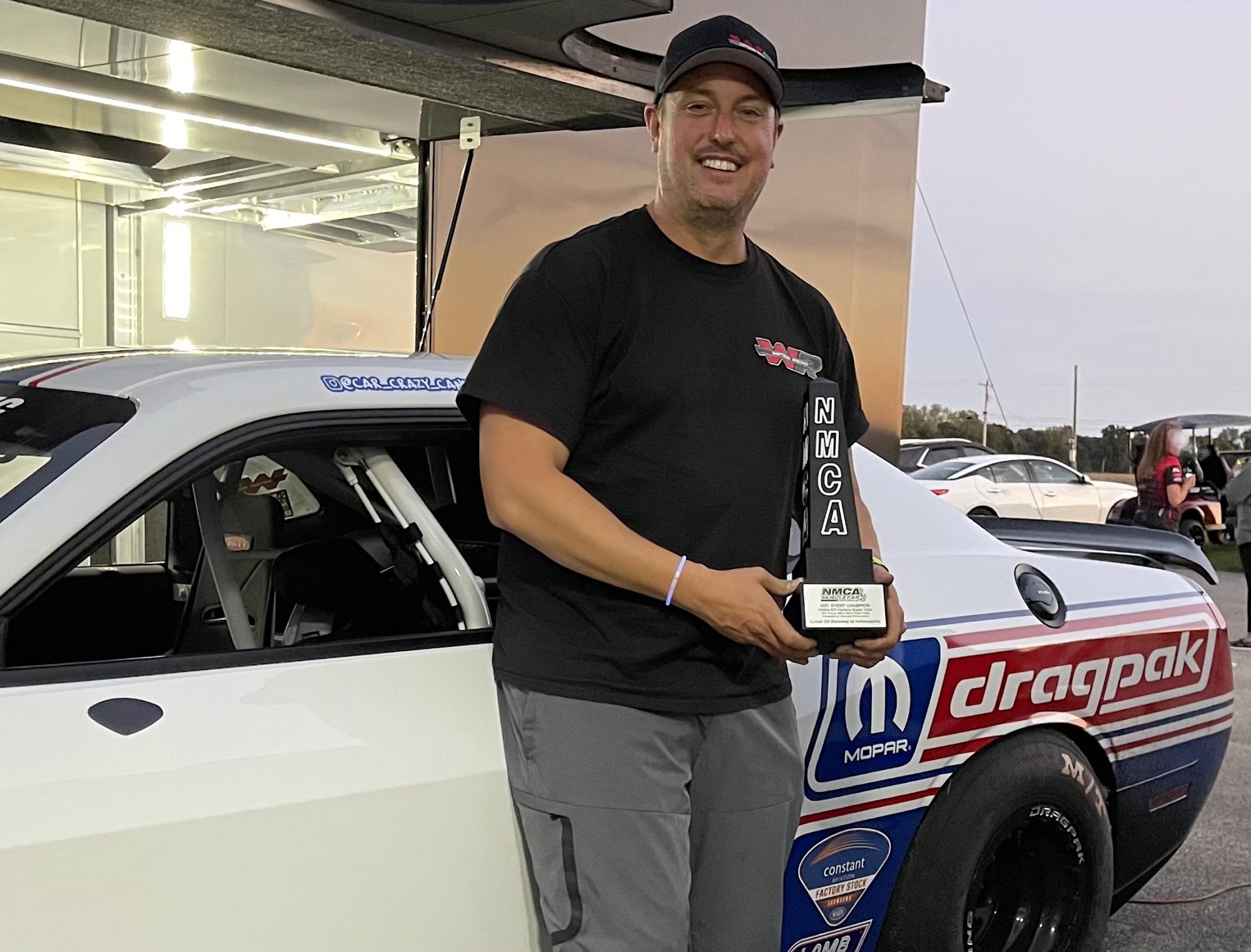 Man holding NMCA trophy