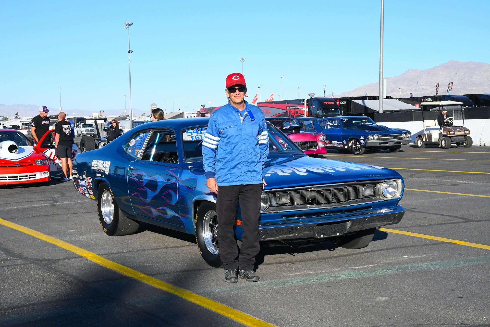 Man standing in front of race car