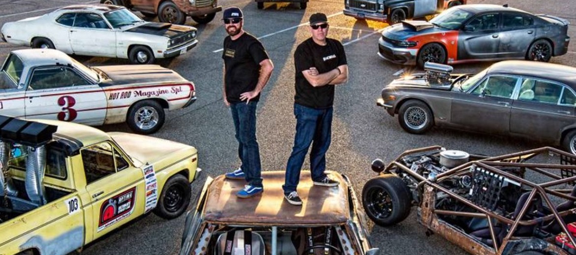 Finnegan & Freiburger standing on top of a car surrounded by other cars