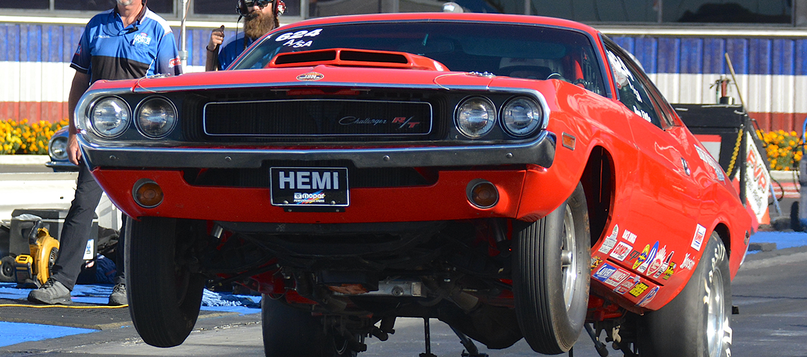 Vehicle doing a wheelie on a drag strip