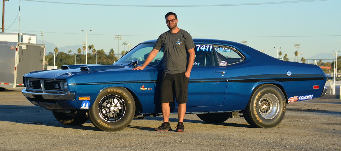 man standing in front of race car