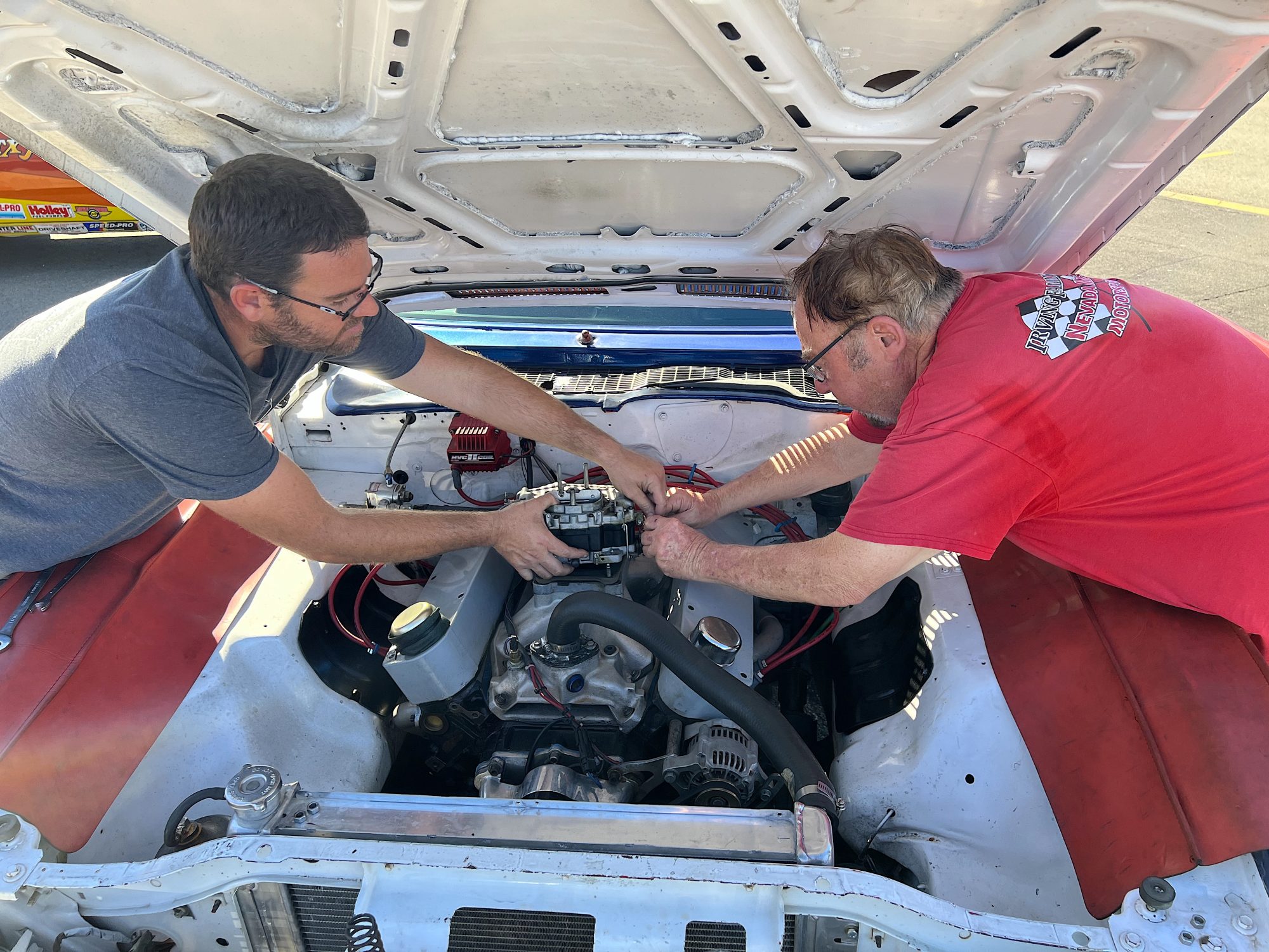 Two men working on an engine