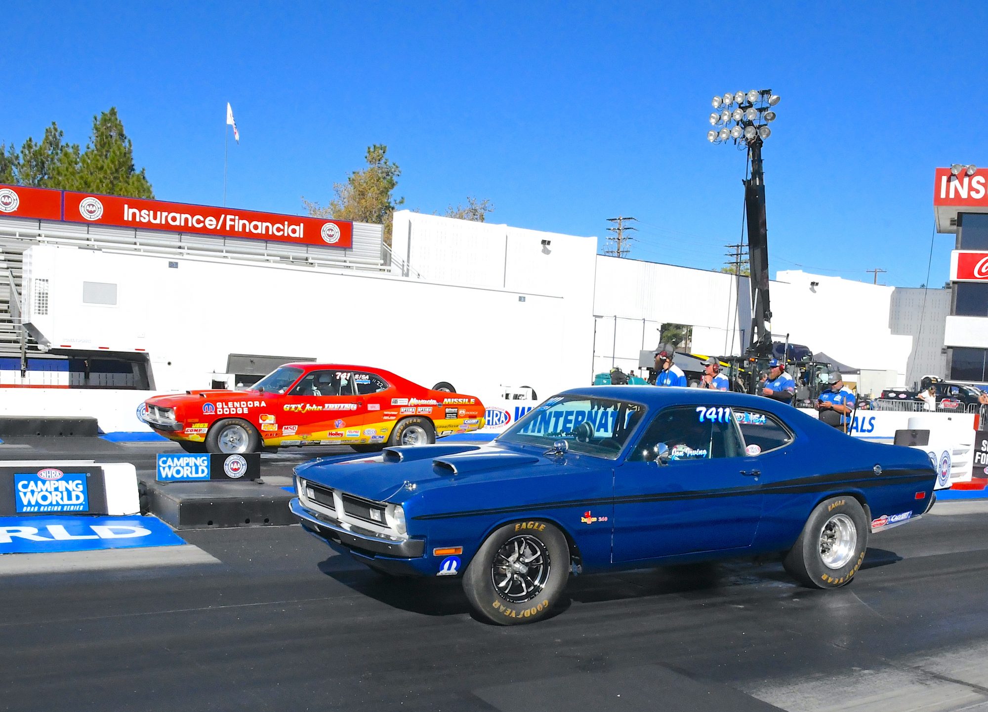 two vehicles lining up to drag race