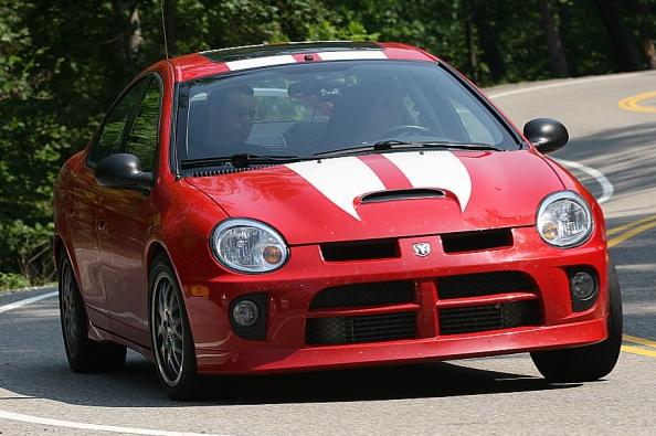 Dodge Neon driving down a winding road