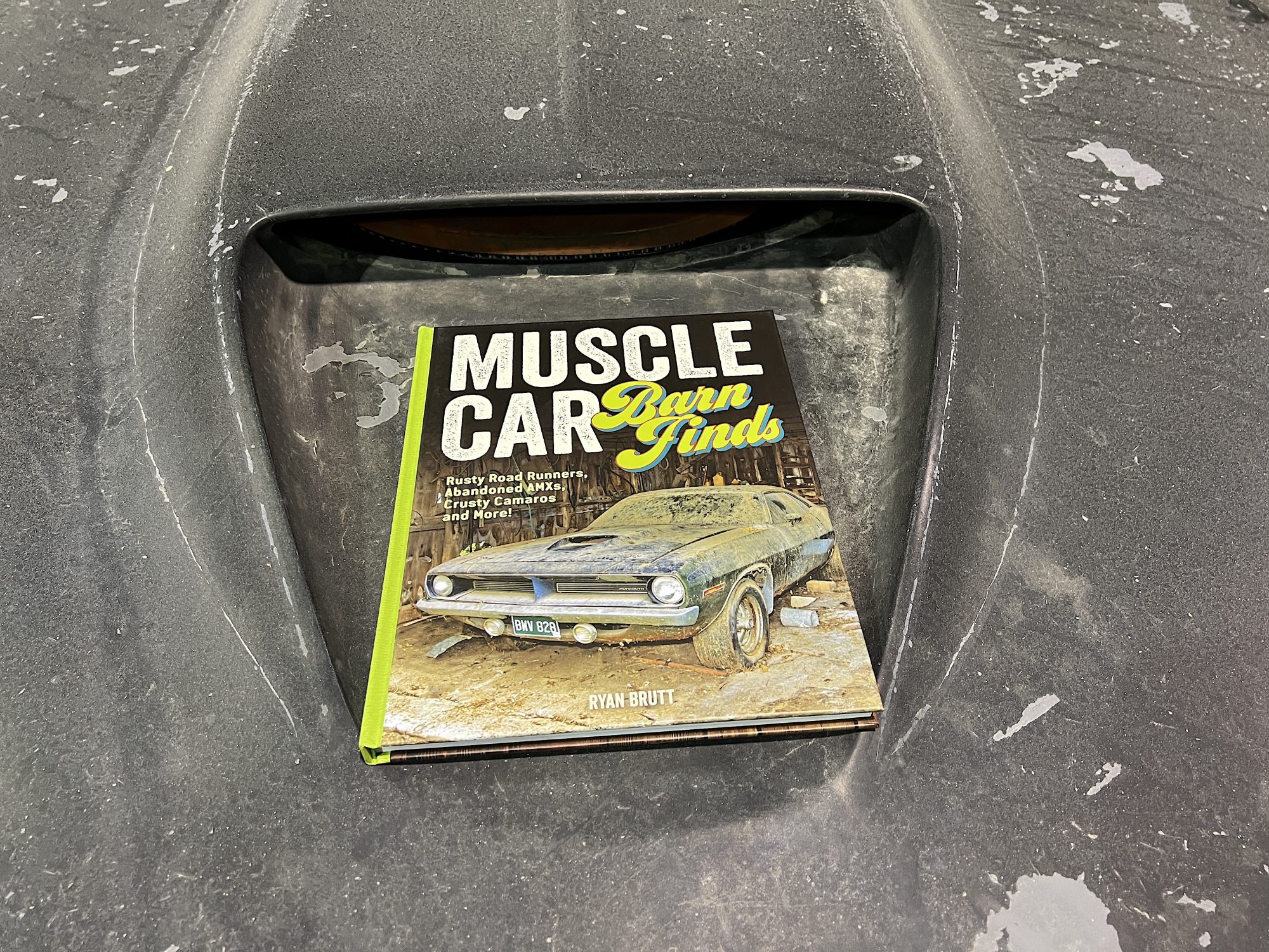 Book sitting on top of vintage vehicle