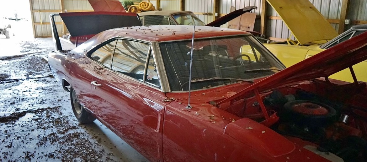 Vintage Dodge vehicles inside a barn