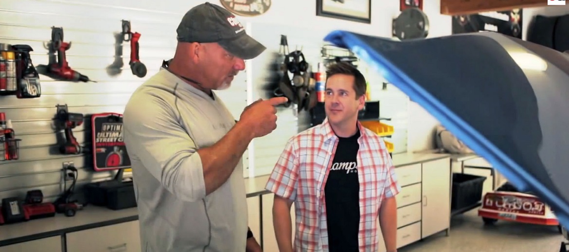 2 men talking in a garage