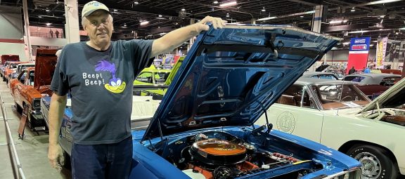 man standing with his car