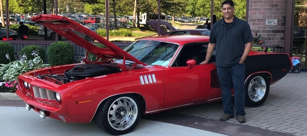 Man standing next to vintage Dodge vehicle