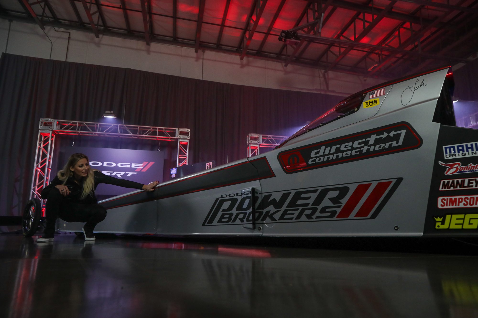 Tony Stewart Racing driver Leah Pruett shows off her Dodge Power Brokers Top Fuel Dragster.