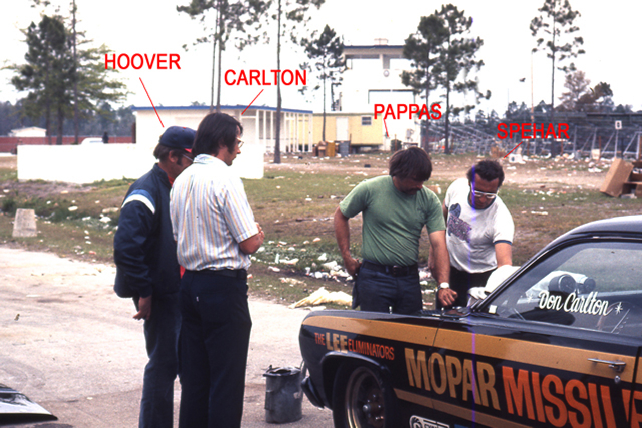 Men checking out a race car