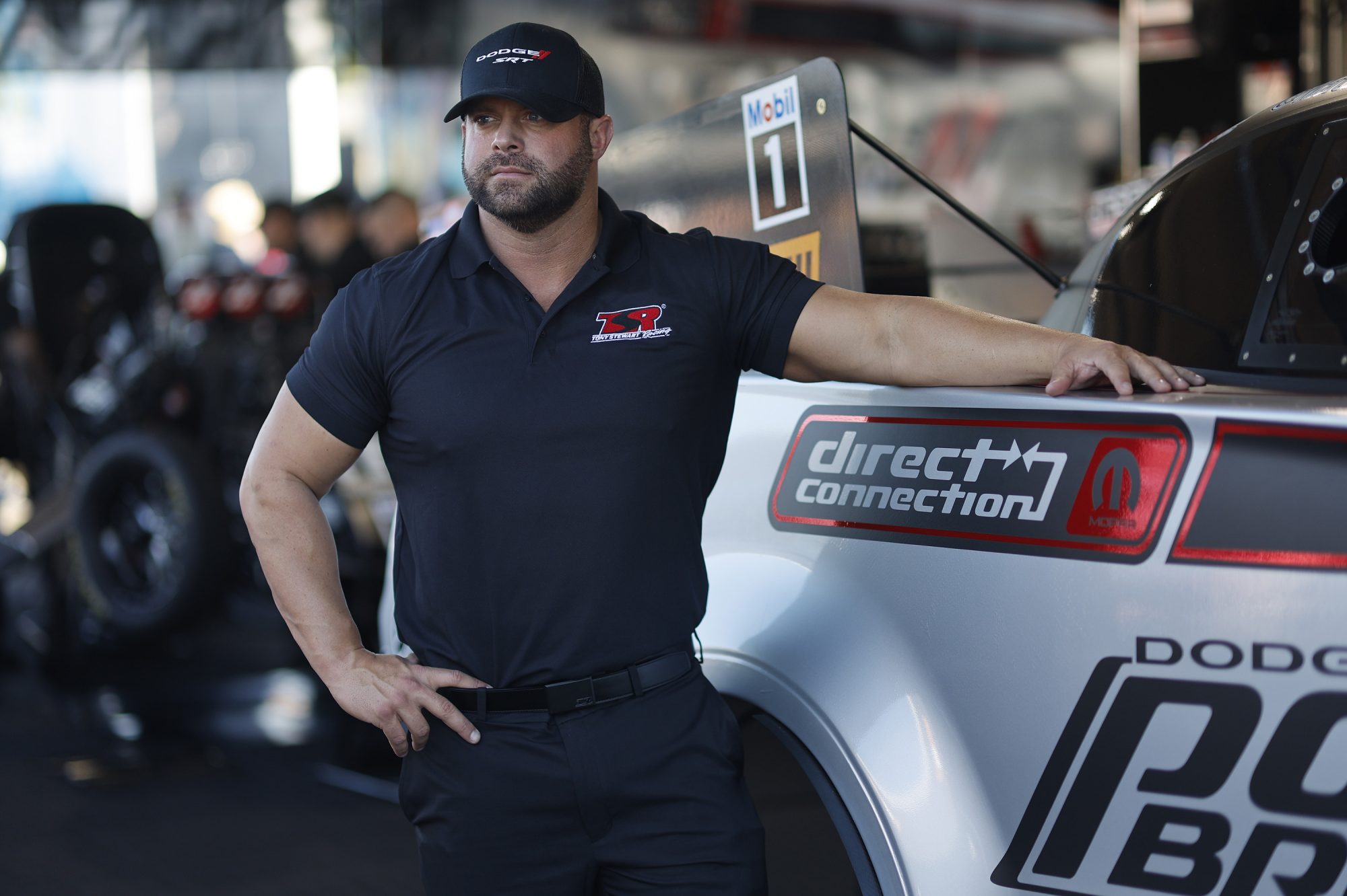 Matt Hagan standing next to his race car